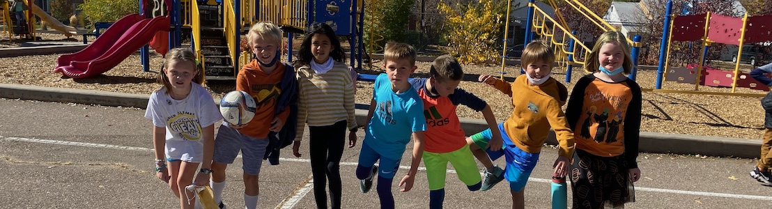 Group of students posing outside on the playground